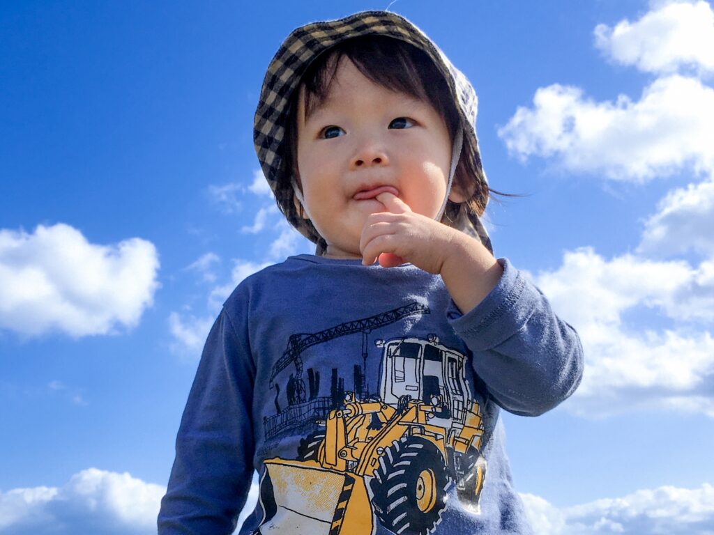 屋外で元気に遊んでいる幼児の写真